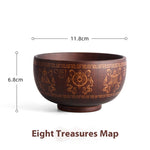 Ethnic wooden bowl with intricate carved patterns, showcasing traditional craftsmanship and rustic decorative style