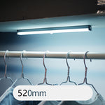 USB rechargeable LED sensor light bar mounted under a cabinet, emitting bright white light with a sleek modern design