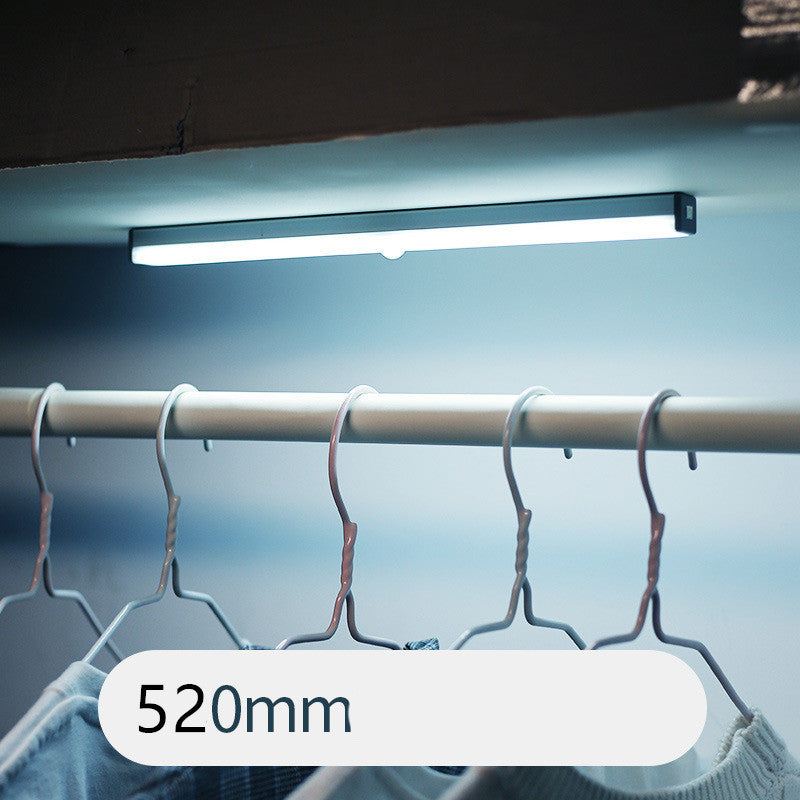 USB rechargeable LED sensor light bar mounted under a cabinet, emitting bright white light with a sleek modern design