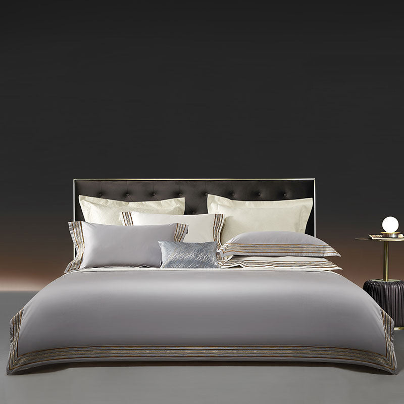 Elegant 4-piece embroidered bedding set with 140 thread count, displayed on a neatly made bed for a luxurious bedroom look