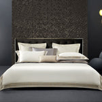 Elegant 4-piece embroidered bedding set with 140 thread count, displayed on a neatly made bed for a luxurious bedroom look