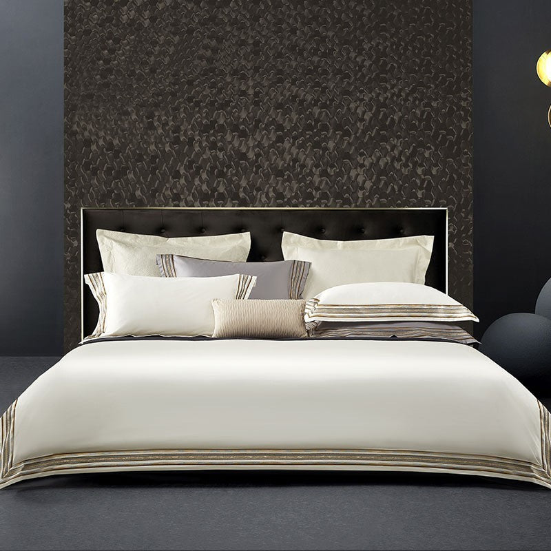 Elegant 4-piece embroidered bedding set with 140 thread count, displayed on a neatly made bed for a luxurious bedroom look