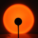 Orange glow from Sunset Projection Lamp - Adjustable Decor, casting a warm circular light for cozy night ambiance.