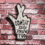 Shapeable LED neon wall decor featuring a hand with crossed fingers and motivational text, mounted on a brick wall background.