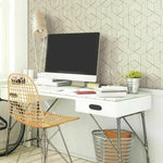 Removable hexagon peel and stick wallpaper in a modern home office with white desk and gold wire chair. Ideal for easy wall upgrades.