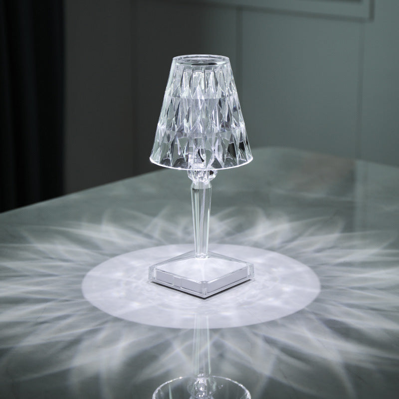 Diamond Portable Wireless Lamp for Bedroom with touch LED lighting, casting radiant white light patterns on a reflective surface.