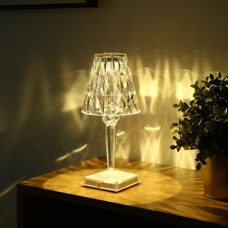 Diamond Portable Wireless Lamp for Bedroom on a wooden nightstand, emitting warm LED light with crystal-like reflections for cozy ambiance.